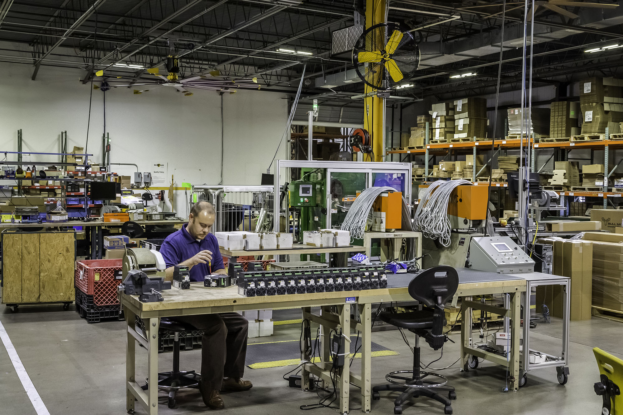 worker assembling electronic controls