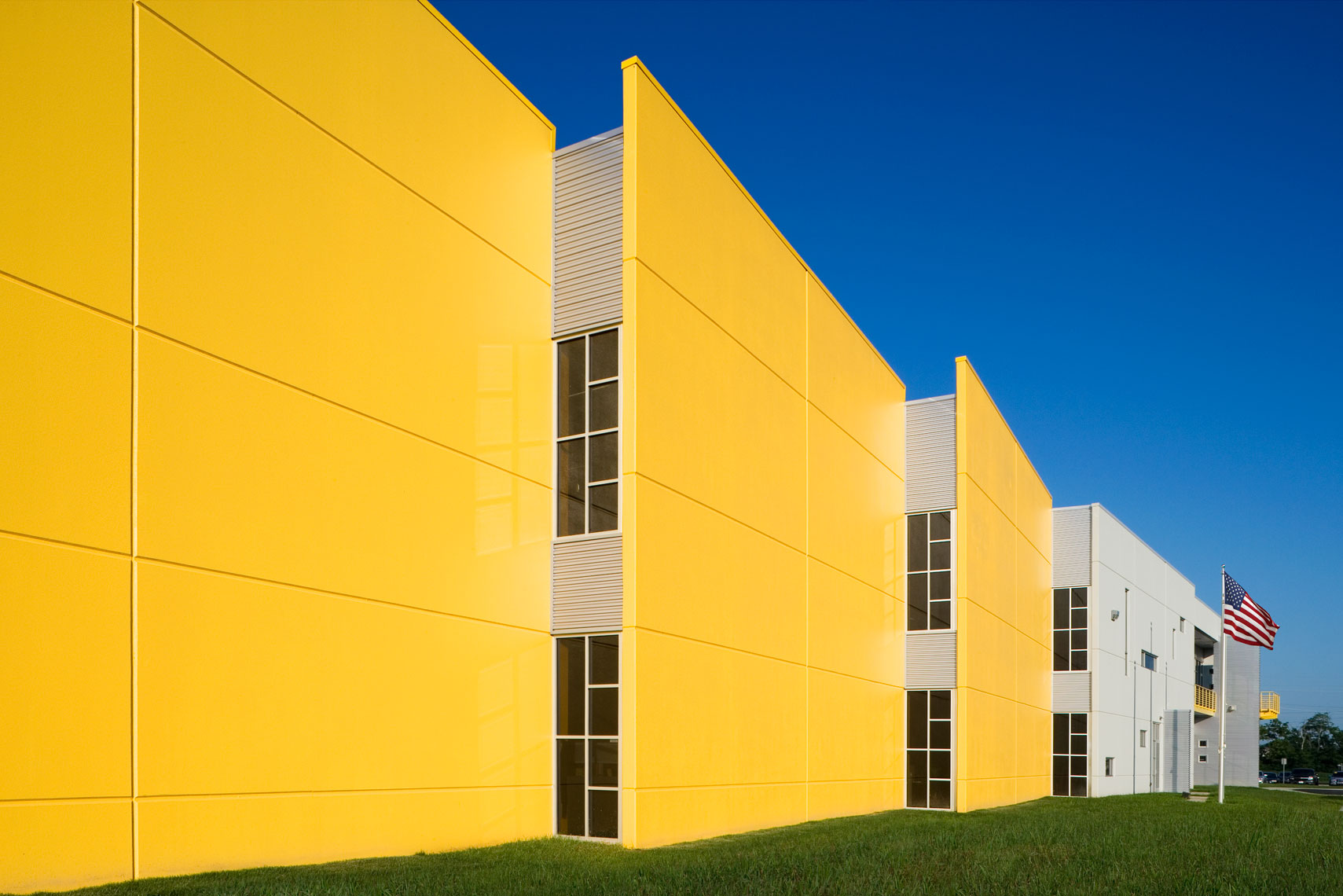 yellow corporate building with flags