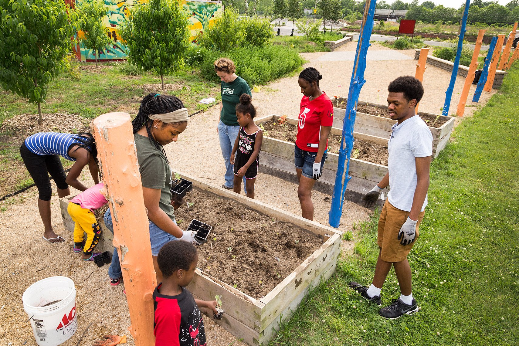 families working on garden plots at urban vacant lot