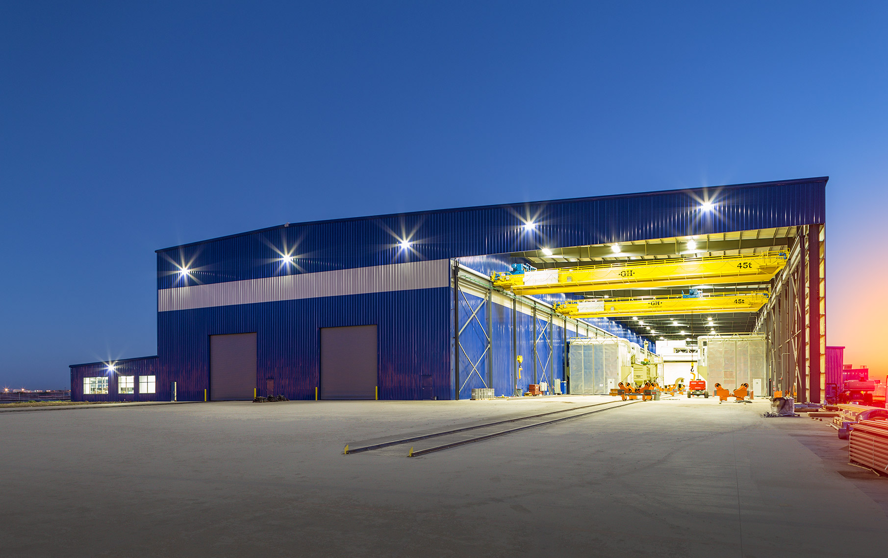 Cranes with exterior bay view at wind tower facility